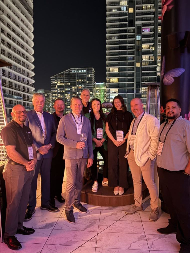 Emily with industry friends on a rooftop at night