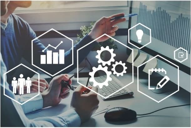 Two people at a desk with digital strategy icons overlaid