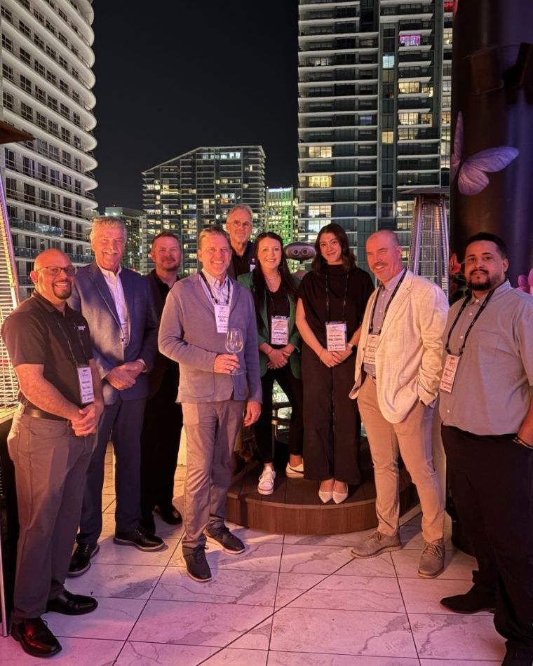 Emily with aviation industry friends on a rooftop at night