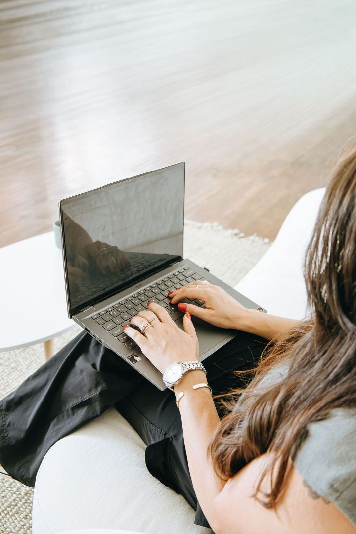 Emily typing on a laptop on her lap